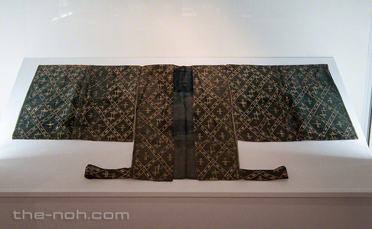 A yellow-green unlined happi (outer robe for a male character) with patterns of diamonds and dragon flies.
