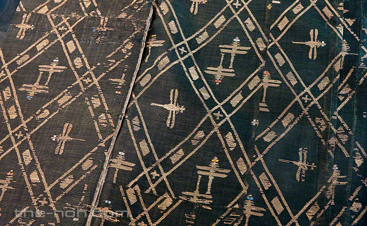 A yellow-green unlined happi (outer robe for a male character) with patterns of diamonds and dragon flies.
